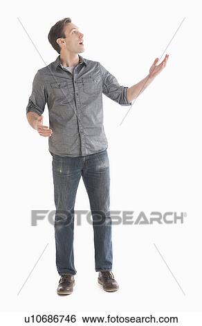 Young man looking up and gesturing View Large Photo Image Stock Photograph - Young man looking up and gesturing. Fotosearch