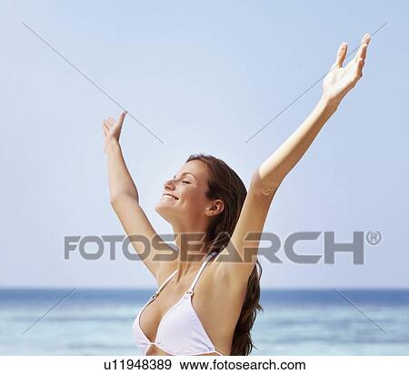 Young woman in bikini, arms outstretched View Large Photo Image Stock Photo - Young woman in bikini, arms outstretched. Fotosearch
