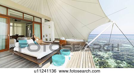 Stock Photograph - Young woman relaxing on deck at summer. Fotosearch