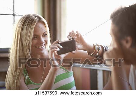 Young woman taking picture with cell phone View Large Photo Image Stock Image - Young woman taking picture with cell phone. Fotosearch