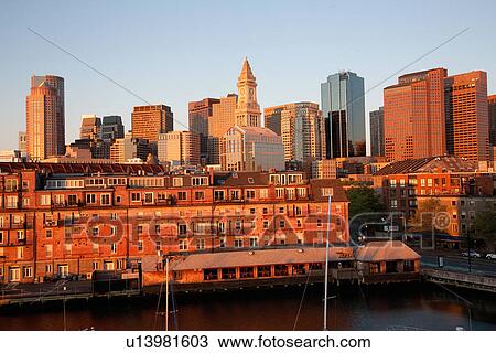 Stock Image - Boston Skyline at sunrise features Commerce House Tower, Boston, MA.. Fotosearch
