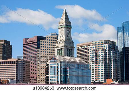 Stock Image - Boston Skyline at sunrise features Commerce House Tower, Boston, MA.. Fotosearch