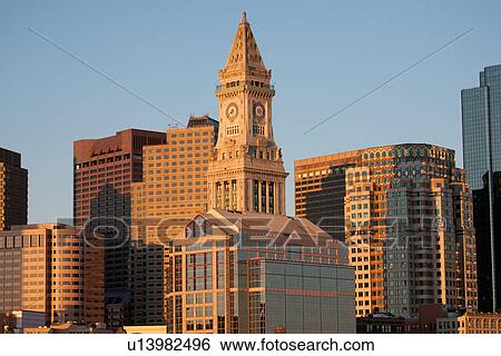 Stock Photograph - Boston Skyline at sunrise features Commerce House Tower, Boston, MA.. Fotosearch