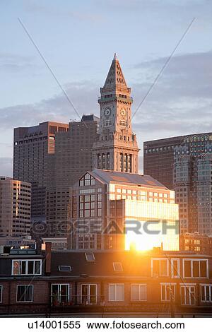 Stock Photography - Boston Skyline at sunset features Commerce House Tower, Boston, MA.. Fotosearch