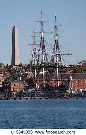 Stock Image - Bunker Hill Monument and USS Constitution historic ship, Charlestown, Boston, MA. Fotosearch