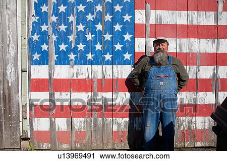 Stock Image - Howard poses in front of US Flag on Old Barn, Maine. Fotosearch