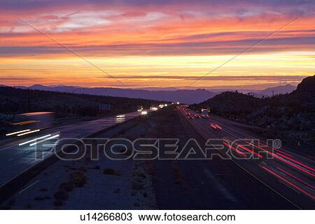 Stock Image - Interstate 15 highway at sunset with traffic to Las Vegas and California. Fotosearch