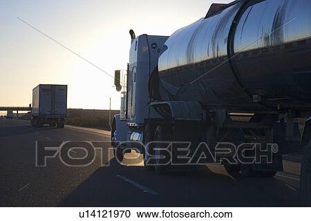 Stock Image - Truck into setting sun on Interstate 15 in California. Fotosearch