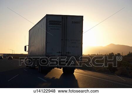 Truck into setting sun on Interstate 15 in California View Large Photo Image Stock Photo - Truck into setting sun on Interstate 15 in California. Fotosearch