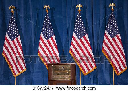Stock Photo - US Flags and Presidential Podium for 2012 Presidential Campaign Rally, Las Vegas, Nevada. Fotosearch