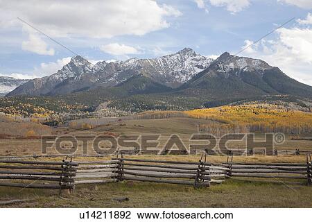 Stock Image - Wooden fence frames Mount Sneffels range on Hastings Mesa, near Ridgeway, CO. Fotosearch