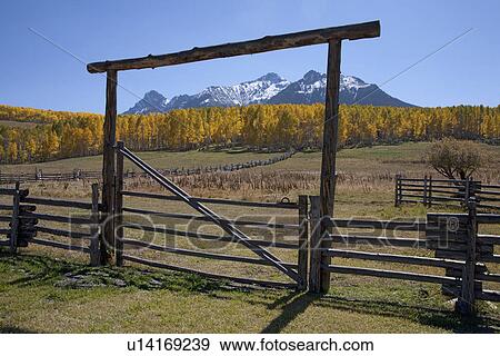 Stock Photo - Wooden fence frames San Juan Mountains, Last Dollar Ranch, Hastings Mesa, near Ridgeway, CO. Fotosearch