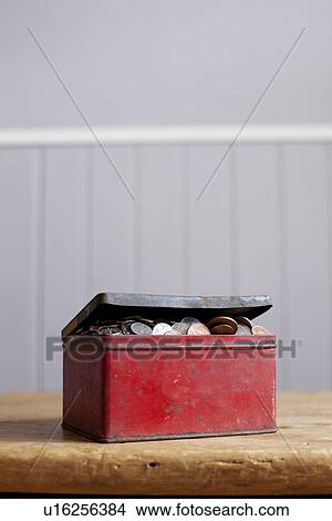 Antique tin full of money on desk View Large Photo Image Picture - Antique tin full of money on desk. Fotosearch