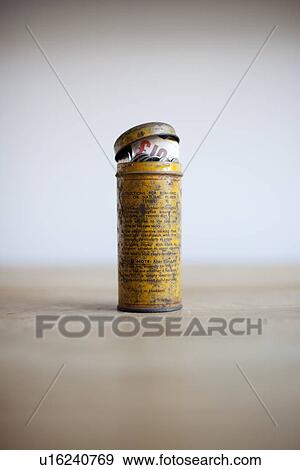 Stock Photo - Antique tin full of money on desk. Fotosearch