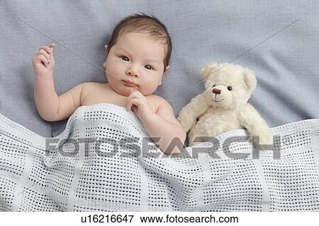 Baby boy and teddy bear laying in bed View Large Photo Image Stock Photo - Baby boy and teddy bear laying in bed. Fotosearch