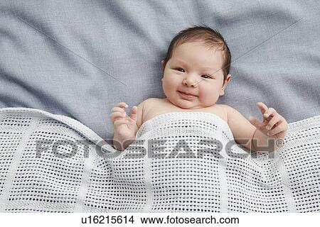 Baby boy laying in bed View Large Photo Image Picture - Baby boy laying in bed. Fotosearch