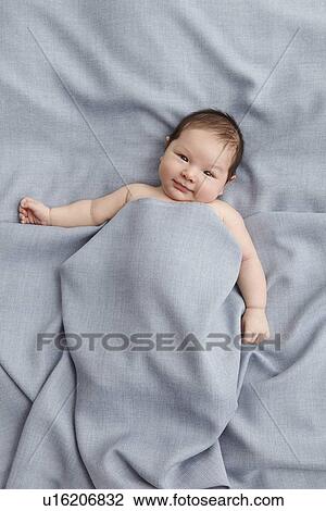 Baby boy laying in bed View Large Photo Image Stock Image - Baby boy laying in bed. Fotosearch