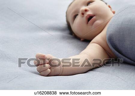 Baby boy laying in bed View Large Photo Image Stock Photo - Baby boy laying in bed. Fotosearch