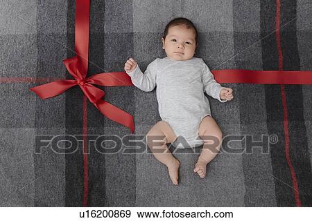 Baby boy laying on bed View Large Photo Image Stock Photo - Baby boy laying on bed. Fotosearch