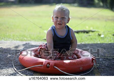 Baby boy sitting in life preserver View Large Photo Image Stock Image - Baby boy sitting in life preserver. Fotosearch