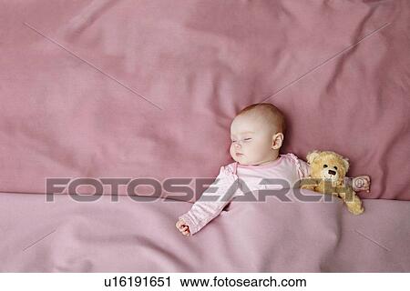 Baby girl sleeping in bed View Large Photo Image Stock Image - Baby girl sleeping in bed. Fotosearch