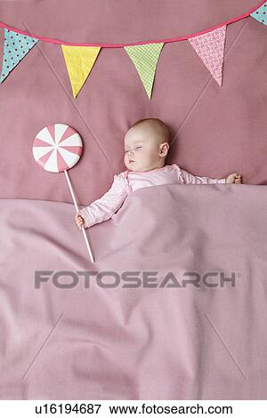 Baby girl sleeping in bed View Large Photo Image Stock Photo - Baby girl sleeping in bed. Fotosearch