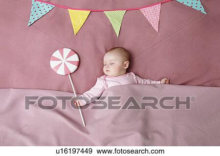 Stock Photo - Baby girl sleeping in bed. Fotosearch