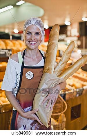 Baker smiling in store View Large Photo Image Stock Image - Baker smiling in store. Fotosearch