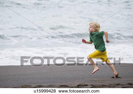Boy running on beach View Large Photo Image Stock Photo - Boy running on beach. Fotosearch