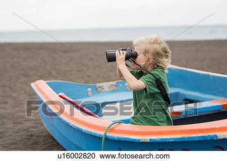 Boy using binoculars on beach View Large Photo Image Stock Image - Boy using binoculars on beach. Fotosearch