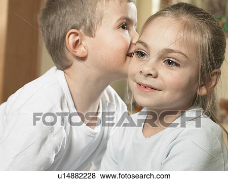 Boy whispering in girls ear View Large Photo Image Stock Photo - Boy whispering in girls ear. Fotosearch