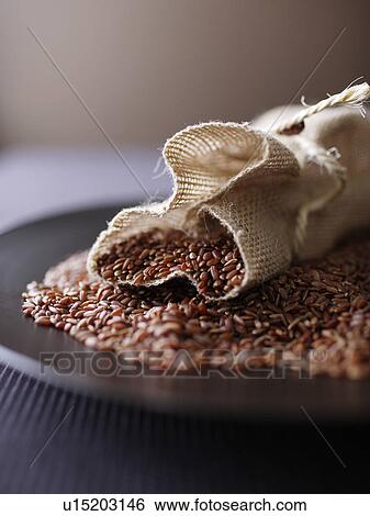 Burlap sack of red rice on plate View Large Photo Image Stock Photograph - Burlap sack of red rice on plate. Fotosearch
