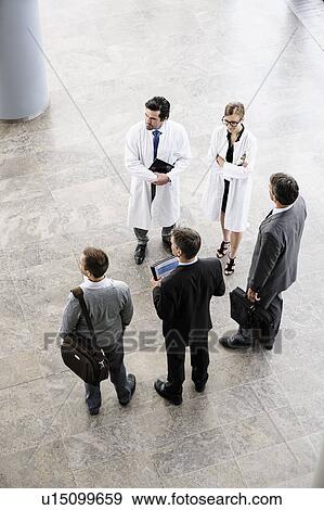 Business people and doctors greeting View Large Photo Image Stock Photo - Business people and doctors greeting. Fotosearch