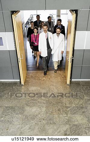 Stock Photo - Business people and doctors in doorway. Fotosearch