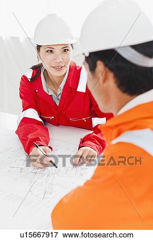 Business people reading blueprints View Large Photo Image Stock Photo - Business people reading blueprints. Fotosearch