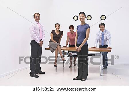 Stock Photography - Business people smiling in office. Fotosearch