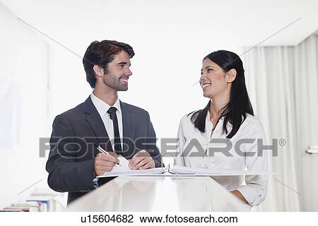 Stock Image - Business people smiling together. Fotosearch