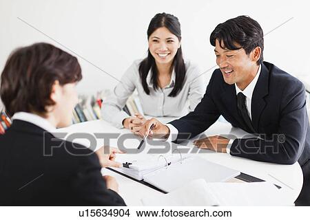 Business people talking at desk View Large Photo Image Picture - Business people talking at desk. Fotosearch