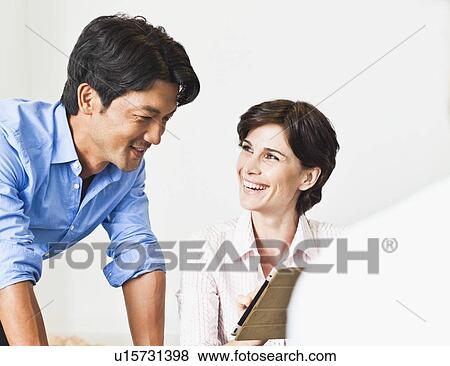 Business people talking at desk View Large Photo Image Stock Photo - Business people talking at desk. Fotosearch