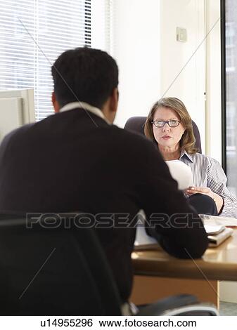 Business people talking at desk View Large Photo Image Stock Photograph - Business people talking at desk. Fotosearch