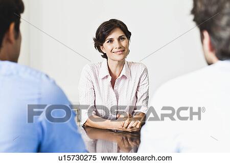 Business people talking at desk View Large Photo Image Stock Photography - Business people talking at desk. Fotosearch