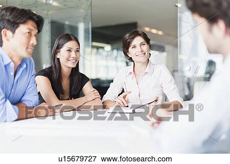 Business people talking in meeting View Large Photo Image Stock Photo - Business people talking in meeting. Fotosearch