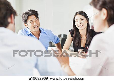 Business people talking in meeting View Large Photo Image Stock Photo - Business people talking in meeting. Fotosearch