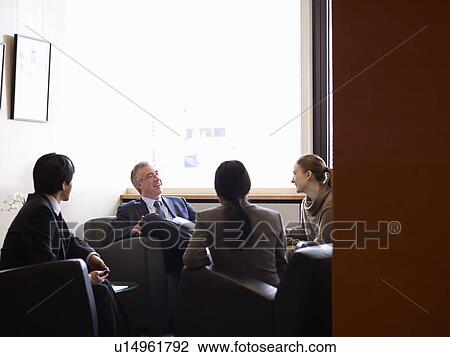 Business people talking in office lobby View Large Photo Image Stock Image - Business people talking in office lobby. Fotosearch