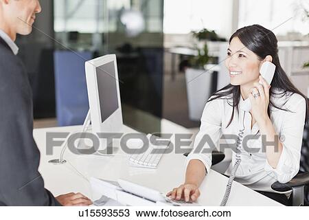Stock Image - Business people talking in office. Fotosearch