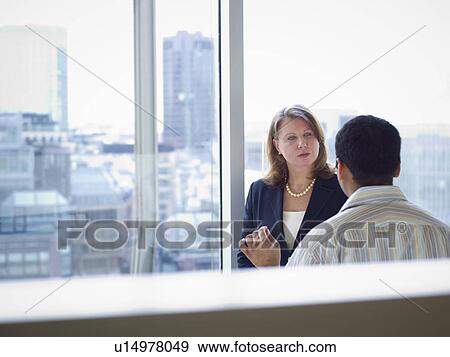 Stock Photo - Business people talking in office. Fotosearch