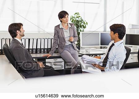 Stock Photo - Business people talking in office. Fotosearch