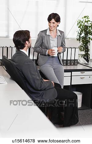 Stock Photo - Business people talking in office. Fotosearch