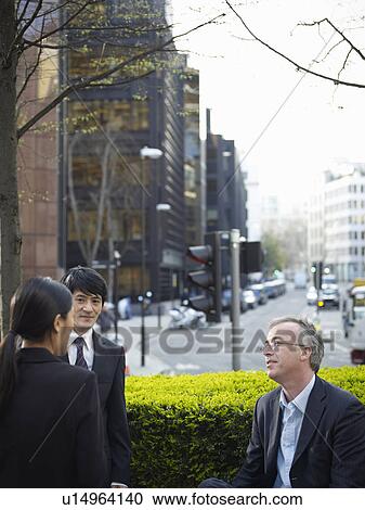 Business people talking on city street View Large Photo Image Stock Image - Business people talking on city street. Fotosearch