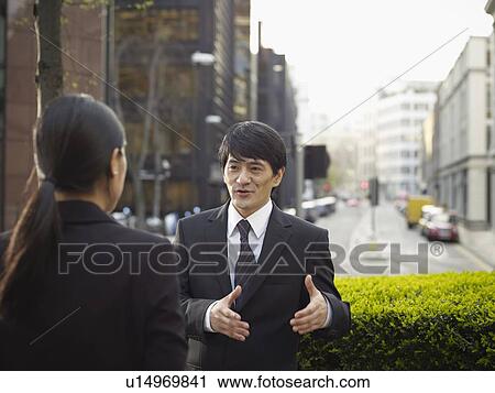 Business people talking on city street View Large Photo Image Stock Image - Business people talking on city street. Fotosearch